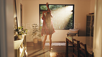 Buy stock photo Back, woman and stretching by window for good morning, freedom and ready to start day in house. Home, sunshine and person with view for wake up, flare and fresh with energy on weekend with peace
