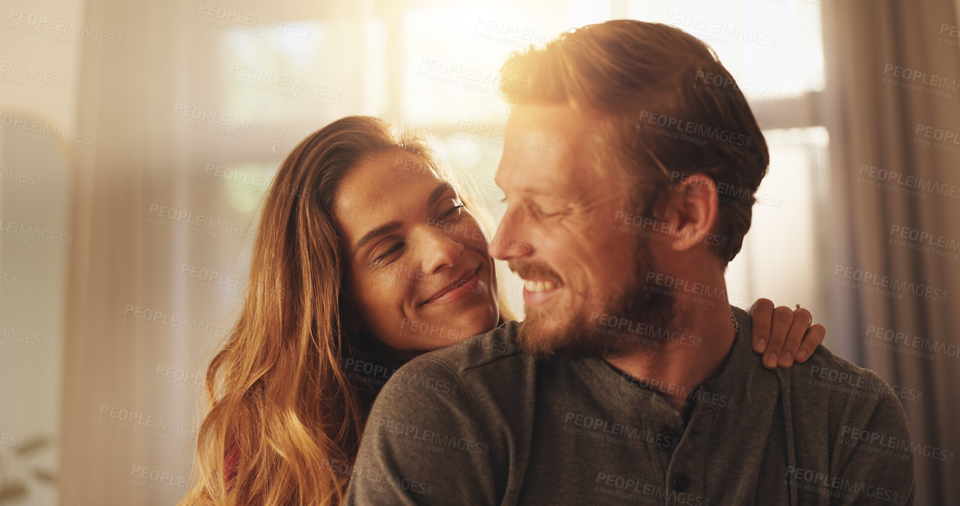 Buy stock photo Smile, couple and embrace in home for care, love and security with partner. Happy man, woman and connection in living room for healthy relationship, loyalty and commitment for marriage together