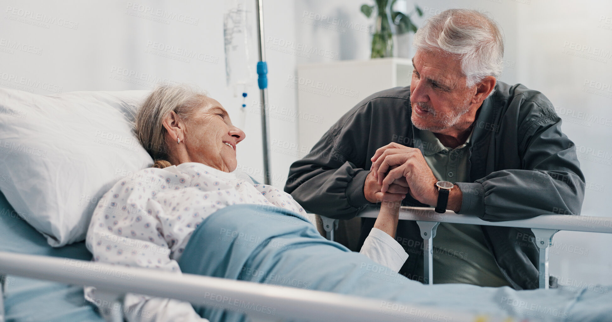 Buy stock photo Holding hands, hospital bed and senior woman with husband for support, love and comfort for recovery. Healthcare, marriage and sick elderly patient with man for empathy and medical healing in clinic.