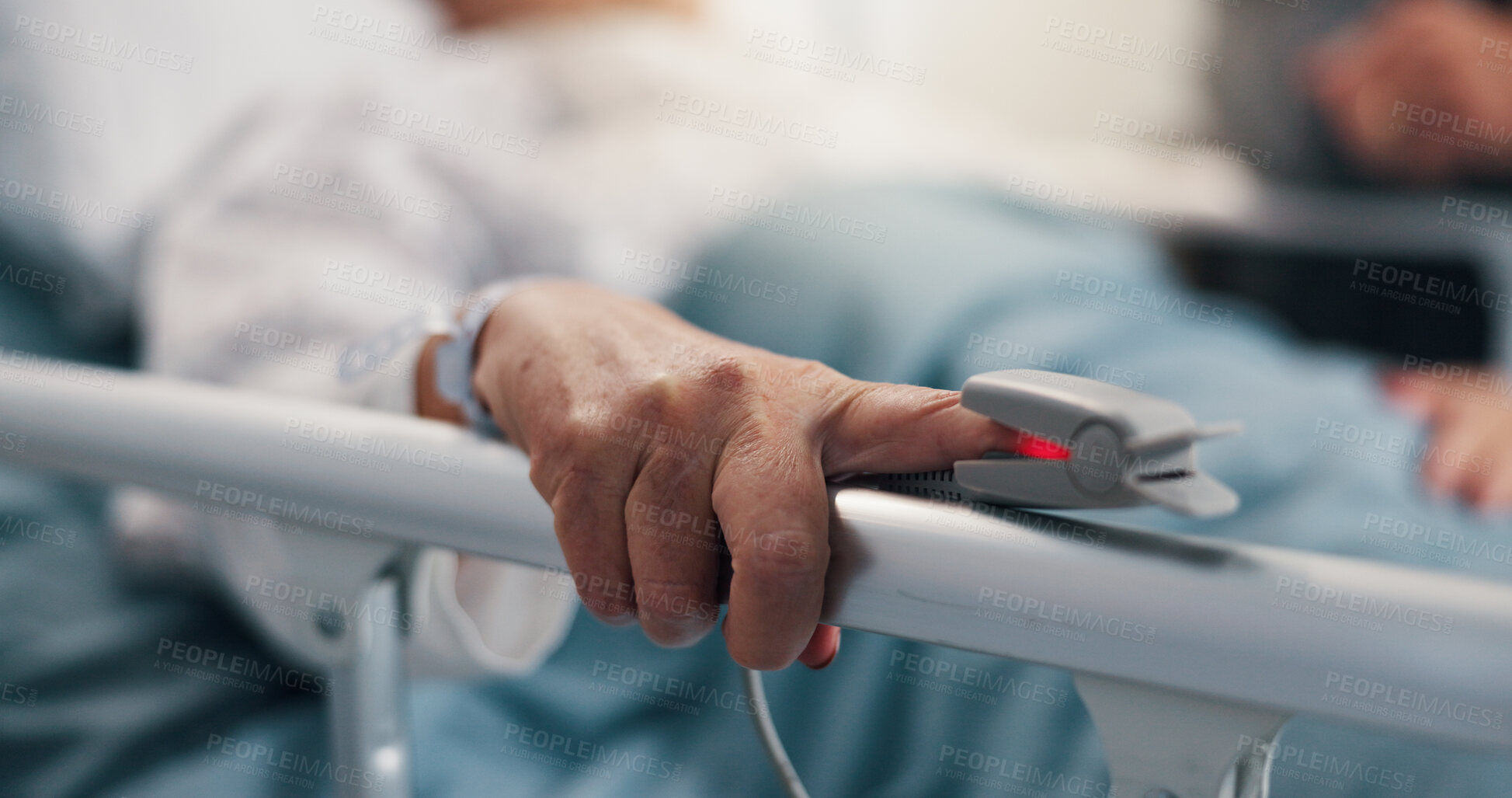 Buy stock photo Hand, senior person and pulse oximeter on hospital bed to measure blood levels, monitor and recovery. Closeup, elderly patient and medical machine to track oxygen, chronic condition and critical care