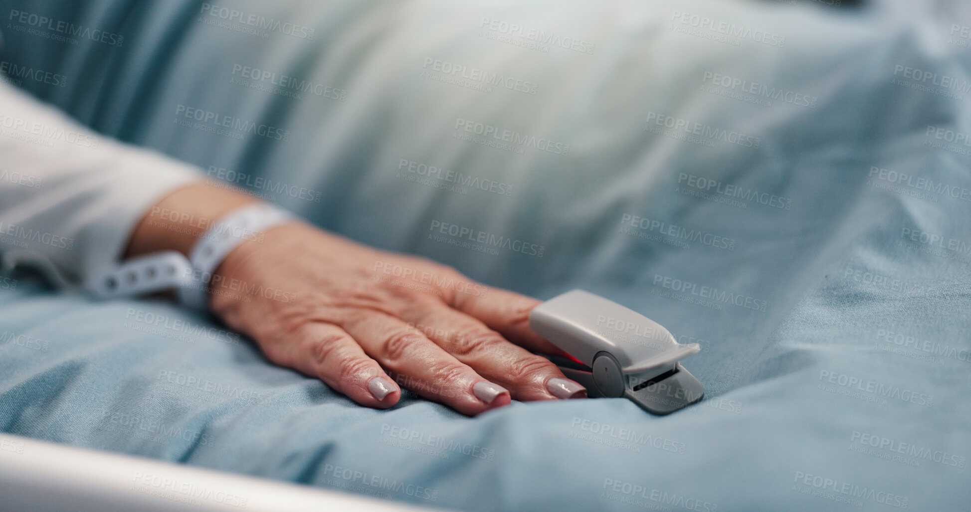 Buy stock photo Hand, person and pulse oximeter on hospital bed to measure blood levels, monitor and recovery. Closeup, senior patient and resting with medical machine, track oxygen and critical care from operation