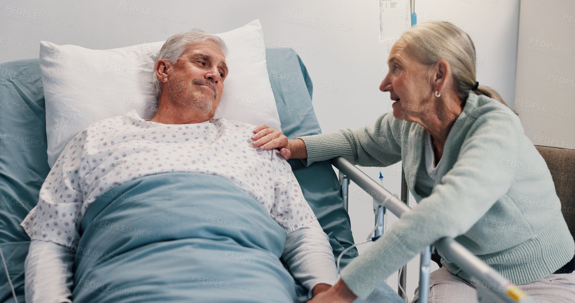 Buy stock photo Senior couple, talk and support in hospital bed for care, love or touch for healing in retirement. Elderly people, woman and man with kindness for trust, loyalty and visit at rehabilitation clinic