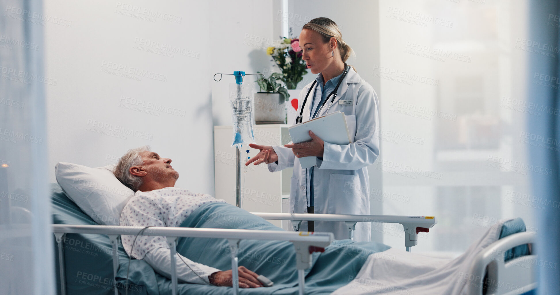 Buy stock photo Doctor, consulting and senior man in hospital bed for healthcare, diagnosis or test results. Conversation, medical records or update with medicine professional and patient in clinic for recovery