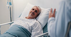 Hospital bed, consultation and doctor with senior man for positive feedback on surgery treatment. Healthcare, relax and medical worker with elderly male patient for recovery advice in clinic.