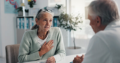 Buy stock photo Hospital, doctor and patient with chest pain, healthcare or medical appointment for help or talking. Consultation, man and listening to symptoms of angina, checkup and senior woman with pressure