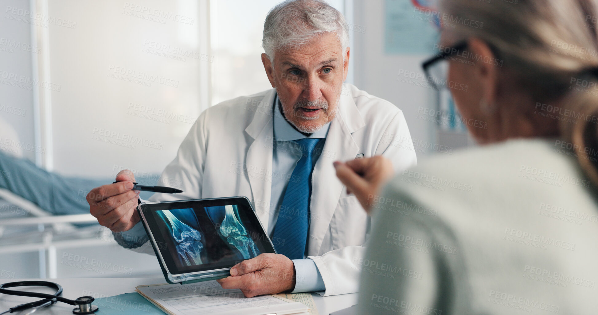 Buy stock photo Doctor, patient and tablet for x ray with knee, screen and osteoporosis with point at hospital. People, application and medical consultation for arthritis, feedback and report for wellness at clinic
