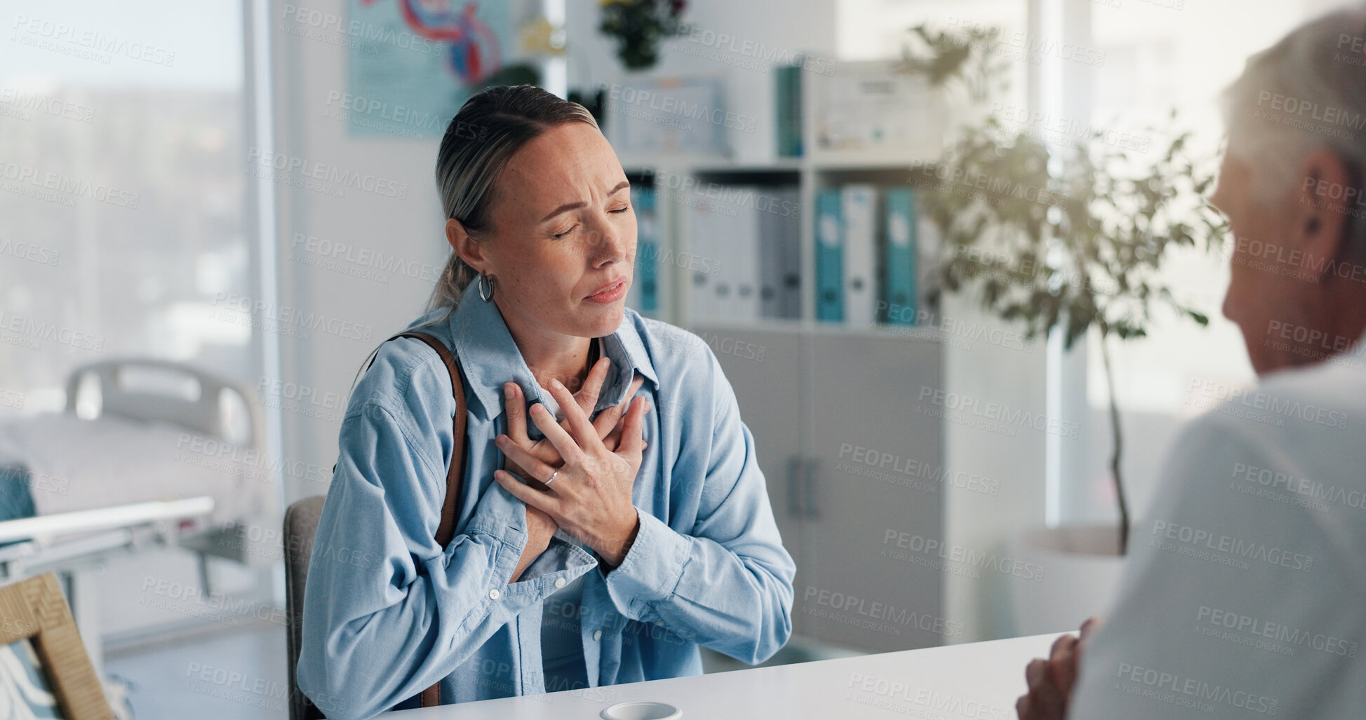 Buy stock photo Hospital, doctor and patient with chest pain, talking or medical appointment for help or healthcare. Checkup, specialist and listening to symptoms of angina, consultation and woman with pressure