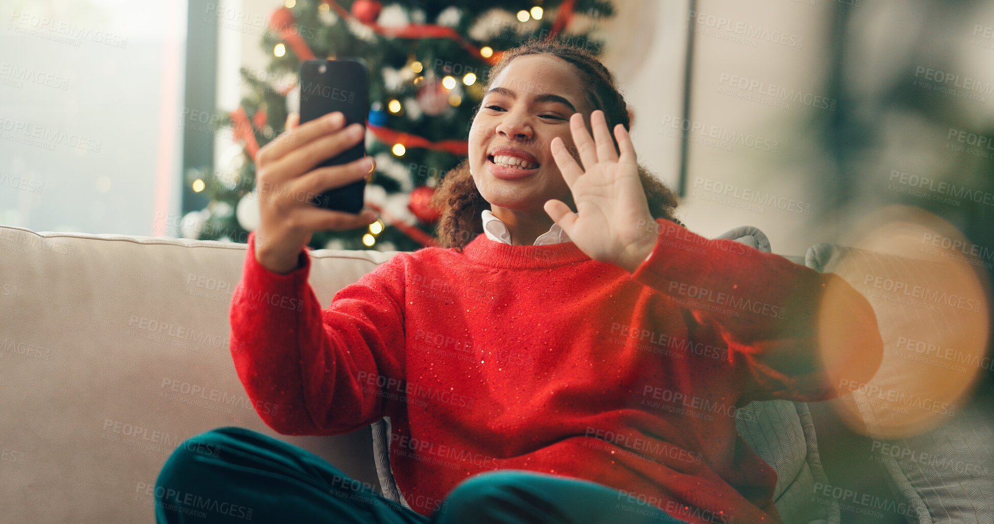 Buy stock photo Christmas, phone and video call with black woman in living room of home for conversation or greeting. App, social media and wave with happy person in apartment for communication or contact on mobile