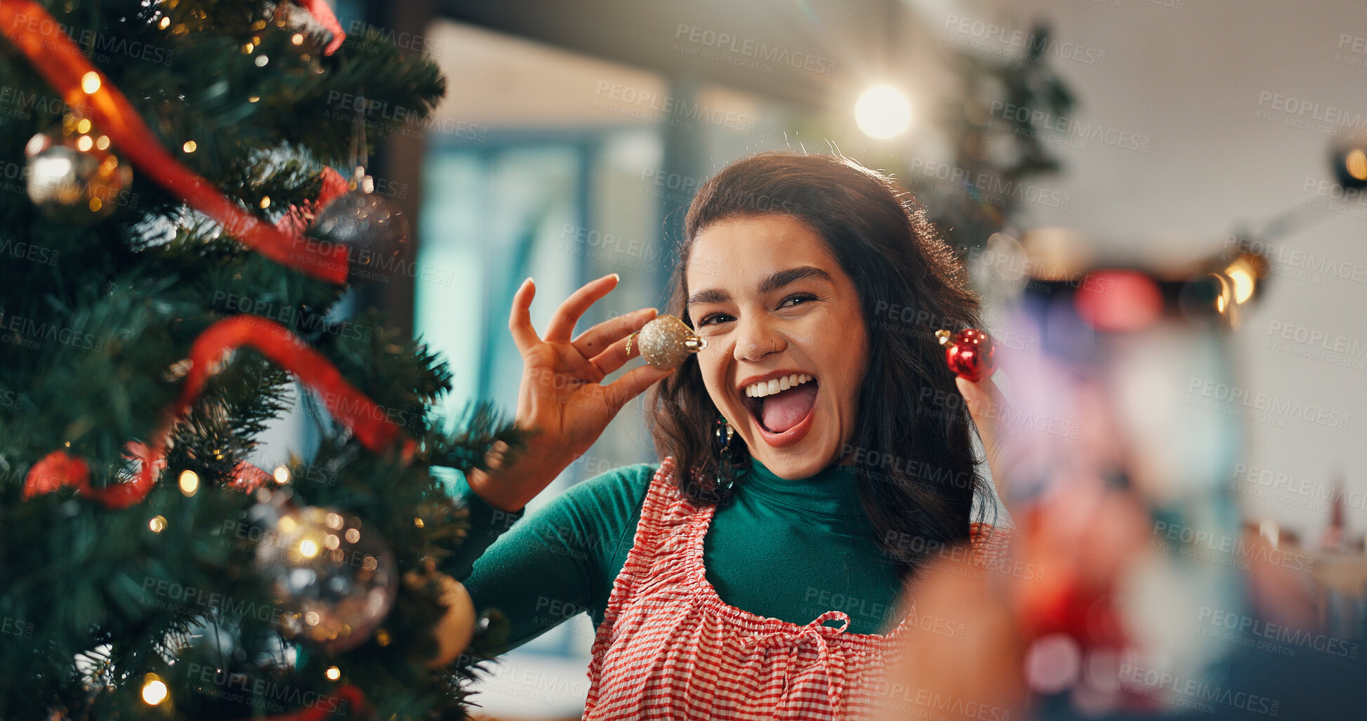 Buy stock photo Christmas, tree and picture with woman and bauble for festive season, memory and decoration. Merry xmas, holiday cheer and photography with person in living room of home for happiness and ornament