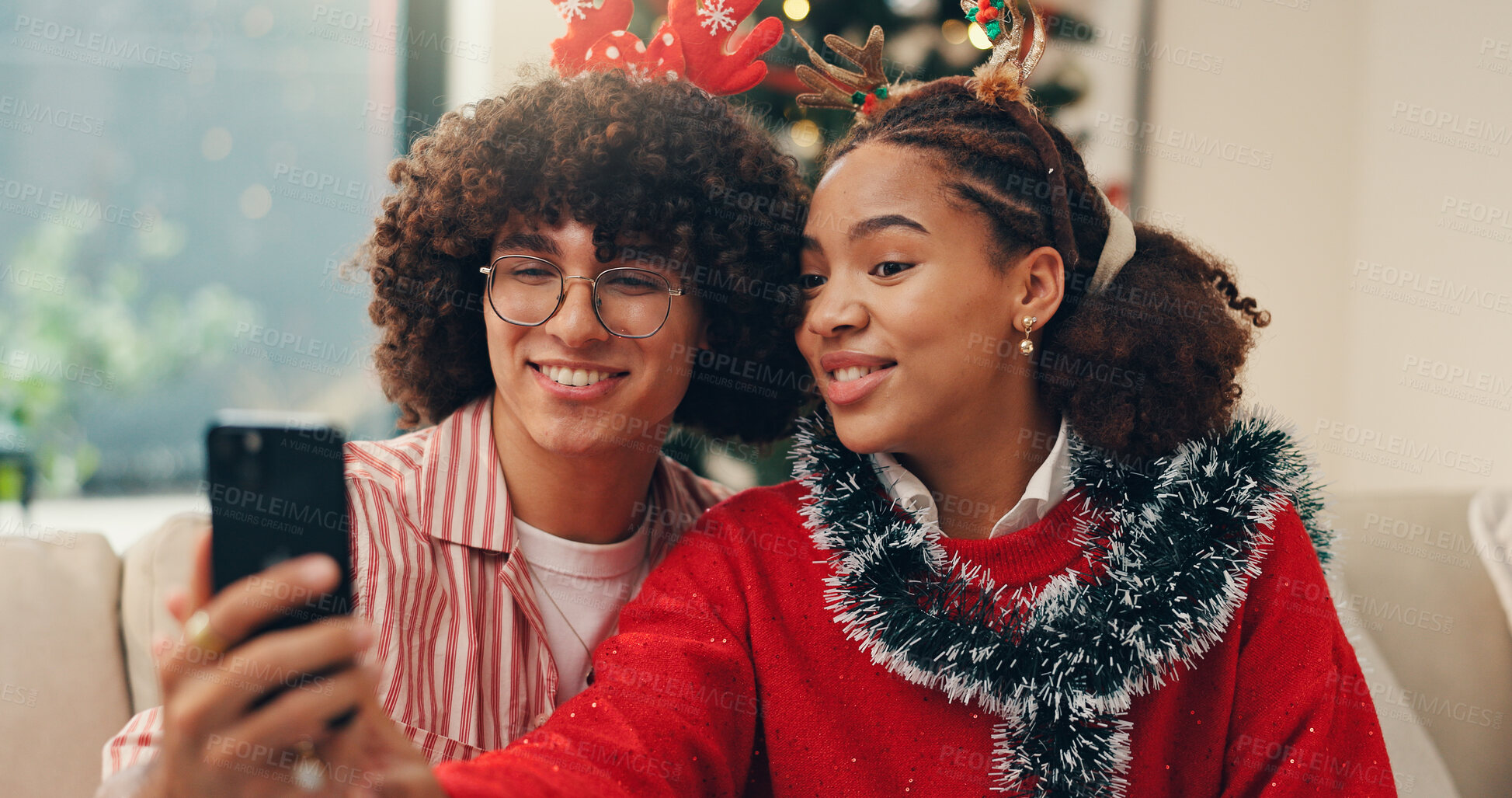 Buy stock photo Christmas, selfie and social media with couple in living room of home for celebration together. December, holidays or season with man and woman in apartment for memory, photograph or profile picture