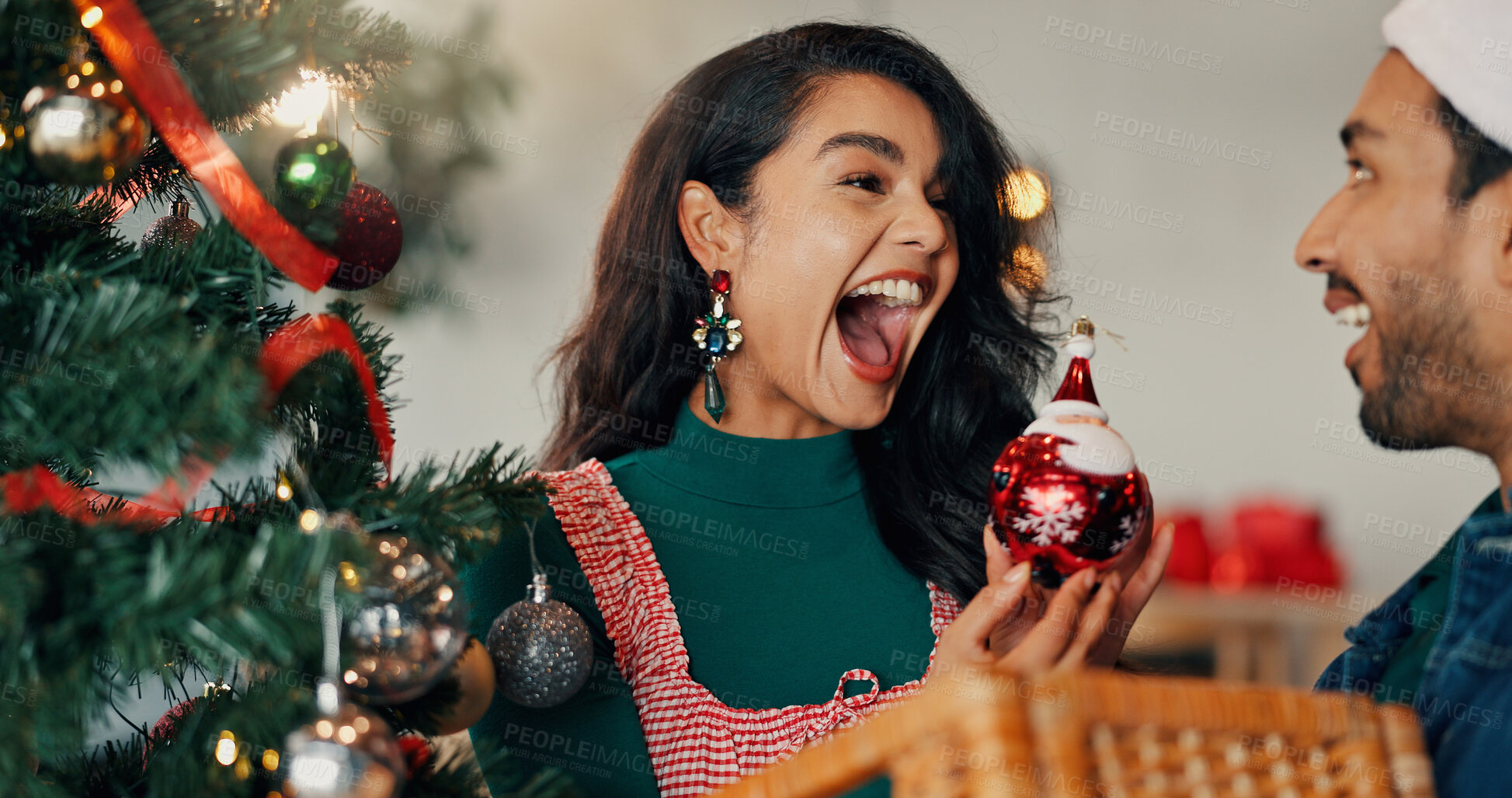 Buy stock photo Christmas, tree and surprise with couple and bauble for festive season, tradition and decoration. Xmas, holiday cheer and celebration with man and woman in living room of home for happy and ornament