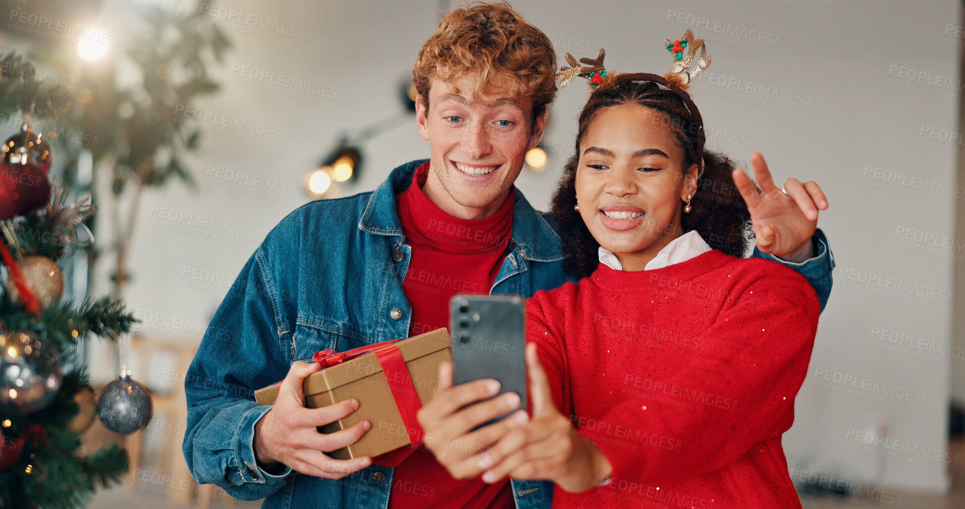 Buy stock photo Happy couple, christmas and selfie with gift for picture or December memory together. Man, woman or lovers with smile, photography or emoji for capture moment, festive holiday or new year celebration