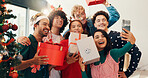 Christmas, gift and selfie with friends in living room of home for holiday celebration together. December, present and season with group of people in apartment for memory, photo or profile picture