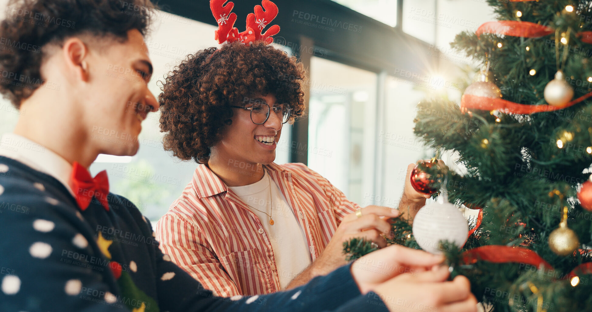 Buy stock photo Christmas, celebration and men with tree, help and bonding together with festive season. People, funny and friends with Xmas event, talking and home with tradition, holiday and decoration with humor