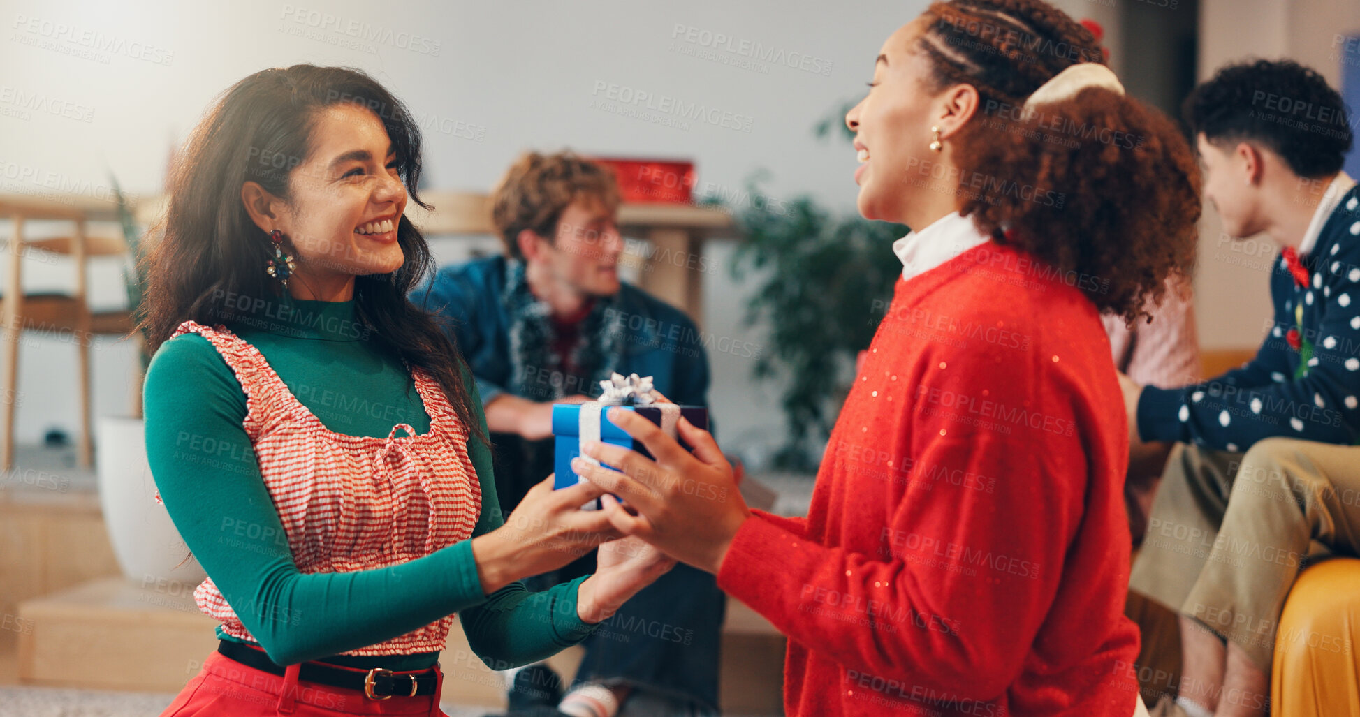 Buy stock photo Christmas, present and box with friends at party for celebration, festive holiday and reunion. Gift giving, support and merry xmas season with people in living room of home for love and social