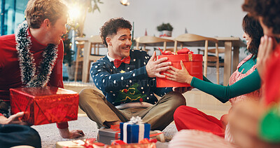 Buy stock photo Christmas, present and surprise with friends at party for love, festive holiday and reunion. Gift giving, support and xmas season with people in living room of home for box, secret Santa or celebrate