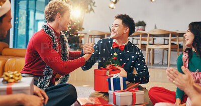 Buy stock photo Christmas, gift and thank you with friends at party for love, festive holiday and reunion. Present, support and xmas season with people and handshake in home for box, secret Santa or celebrate