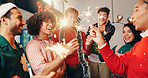Happy people, sparklers and christmas with fireworks for new year or festive celebration in home. Excited, group or friends with smile or sparks in joy for party, event or fun get together at house