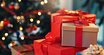 Christmas, boxes and gifts in home for celebration, party or event with festive tradition. Decorations, packages and cardboard presents with ribbon by tree for xmas with holiday season in house.