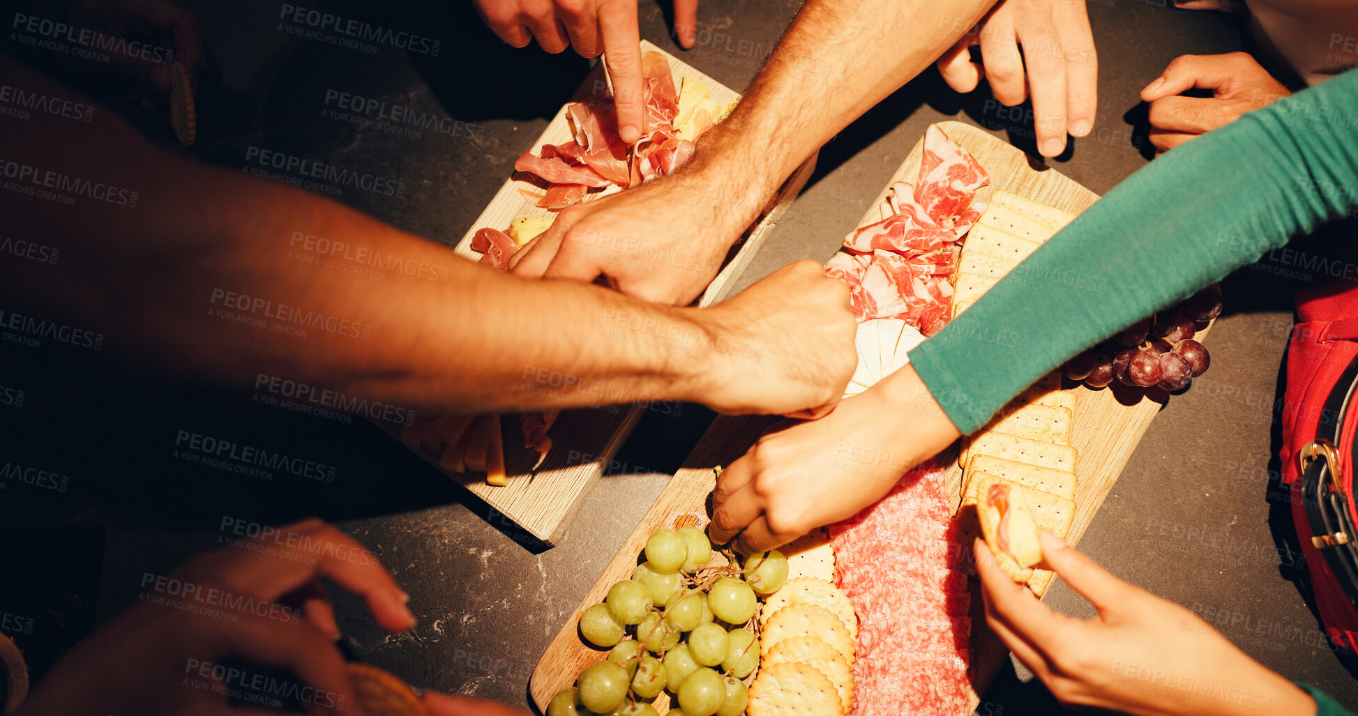 Buy stock photo Charcuterie board, eating and hands with people in home for celebration, cuisine or social gathering. Buffet, food and selection with group of friends closeup in apartment for culinary presentation
