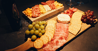 Buy stock photo Charcuterie board, party and snacks on table in home with biscuits, cold meats and cheese for food. Catering, fruit and wooden plate with fresh ingredients and crackers for gourmet selection.