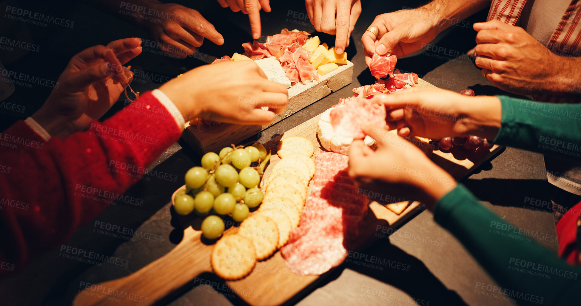 Buy stock photo Charcuterie board, hands and food with people in home for celebration, eating or social gathering. Buffet, cuisine and selection with group of friends closeup in apartment for culinary presentation