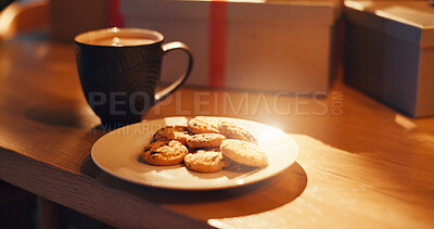 Buy stock photo Cookies, coffee and table at house for Christmas celebration, festive tradition or warm hospitality. Hot chocolate, sweet snack and ritual to welcome Santa Claus, holiday culture and gifting presents