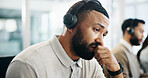 Burnout, headache and thinking with man in call center for help or solution as virtual assistant. Anxiety, headset and stress with agent in coworking office for customer service or online support