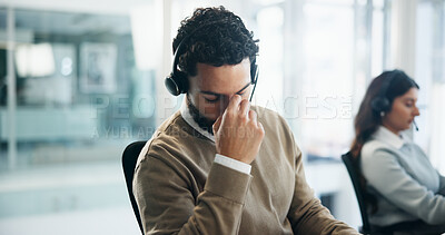 Buy stock photo Headache, tired and call center with business man in office for crisis hotline, depression or contact us. Fatigue, mental health helpline and emergency support with person in agency for consultant