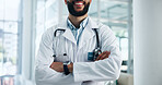 Arms crossed, doctor and man pride in healthcare profession with help, advice and kindness at hospital. Confidence, about us and physician for medical care, health and wellness for smile at clinic