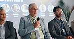 Conference, presentation and mature man with microphone for development, seminar or forum. Convention, speech and workshop with motivational speaker with business coaching, lecture and auditorium