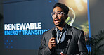 Man, speaker and mic with speech at conference for renewable energy transition at seminar. Person, public speaking and awareness for climate change, eco friendly solution and expo for hydrogen fuel
