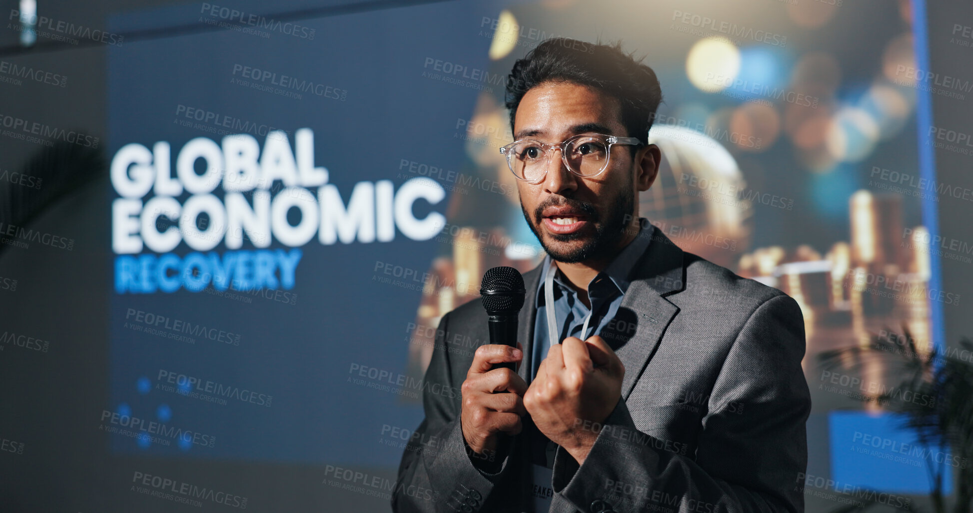 Buy stock photo Meeting, speaker and man with mic, serious and presentation for global economic recovery and speech. Talking, presenter and encouragement for world investment, person and public speaking in seminar