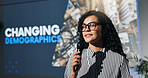 Convention, speech and business woman with microphone for demographic, training or forum. Conference, presentation and workshop with motivational speaker for coaching, lecture and event in auditorium