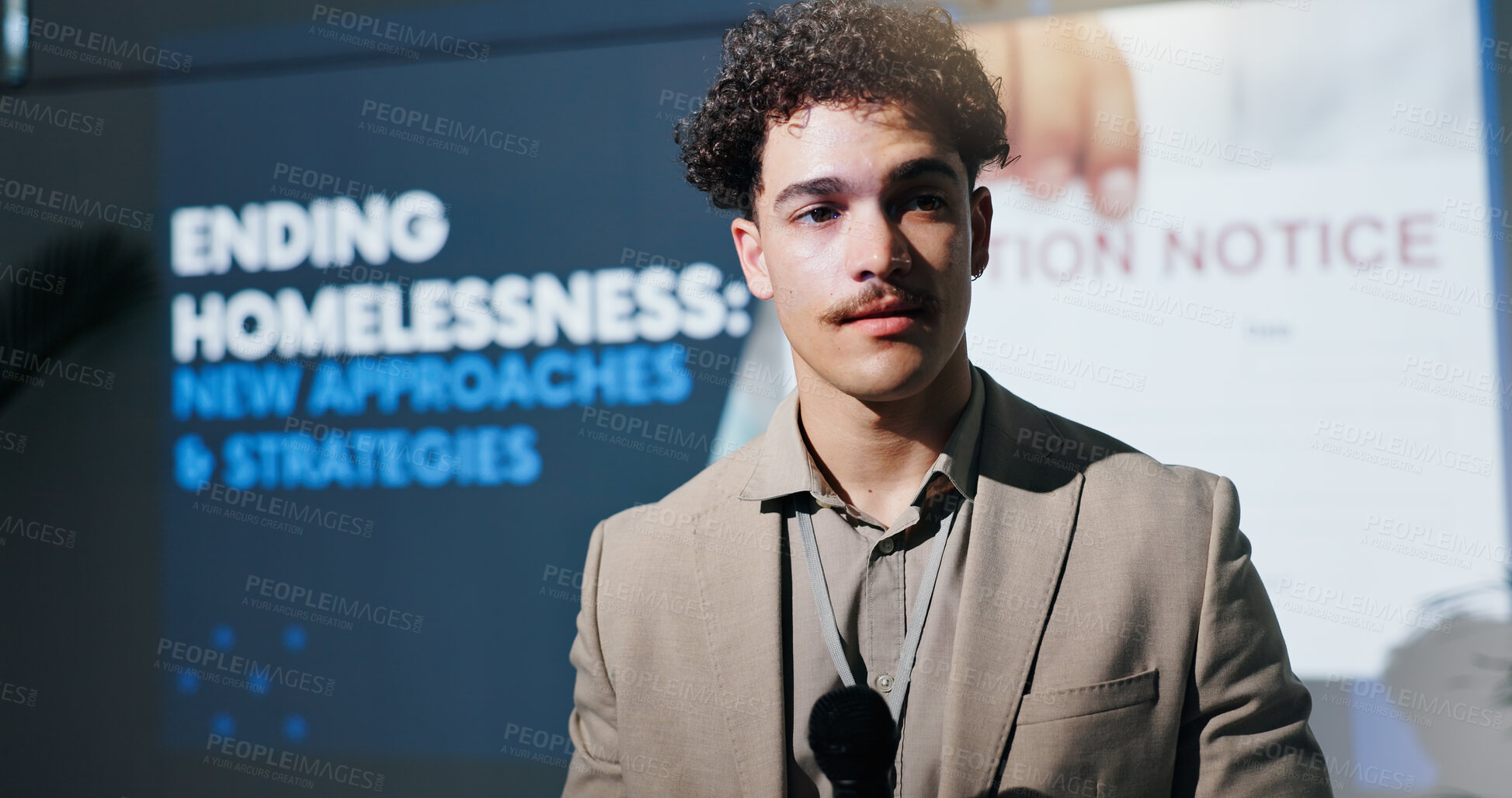 Buy stock photo Man, speaker and mic at conference event with awareness speech for ending homelessness. Person, public speaking and solution for permanent residence, economic housing and information for settlement