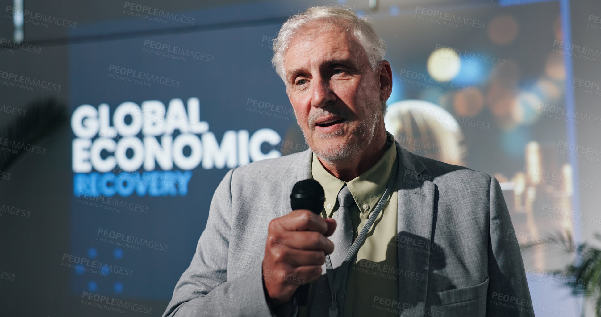 Buy stock photo Presentation, speaker and man with mic, speech and serious for global economic recovery and meeting. Stage, presenter and motivation for world investment, public speaking and mature person in seminar