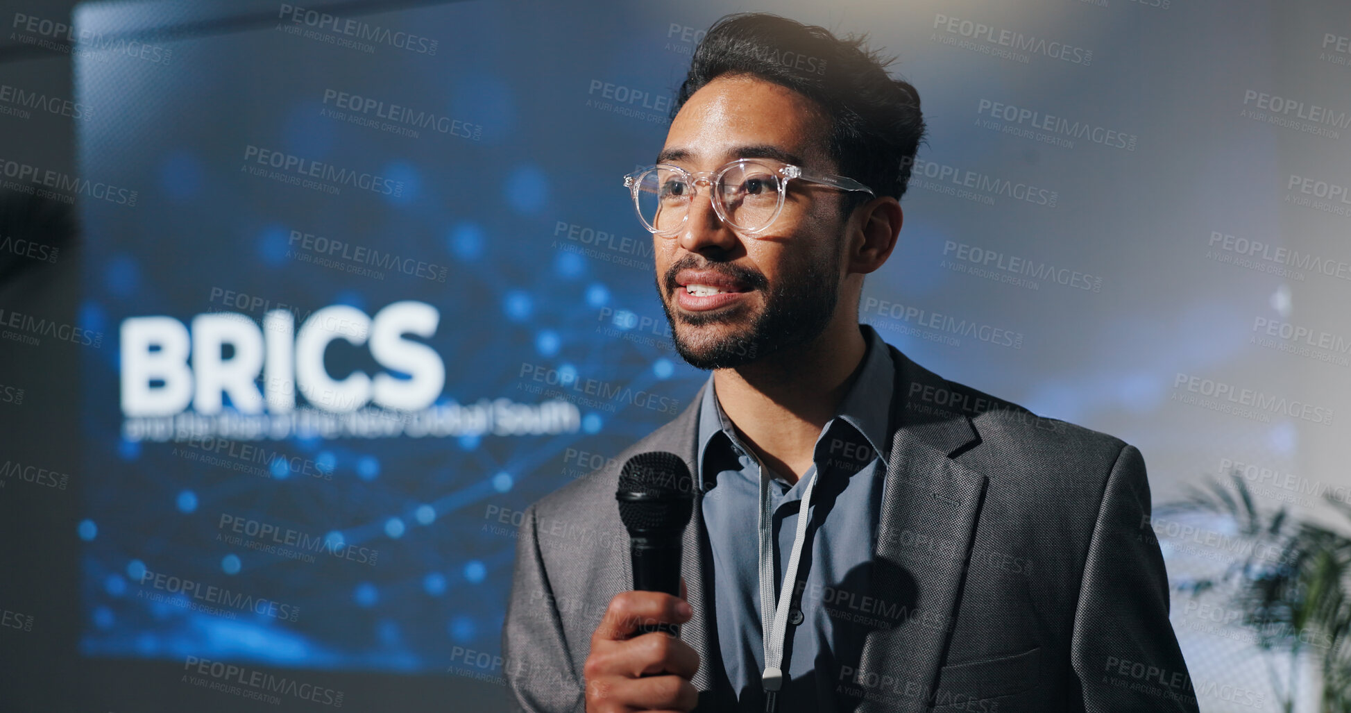 Buy stock photo Microphone, seminar and speech with business man in auditorium for presentation on BRICS union. Development, symposium and workshop with speaker on podium or stage for economic conference and forum
