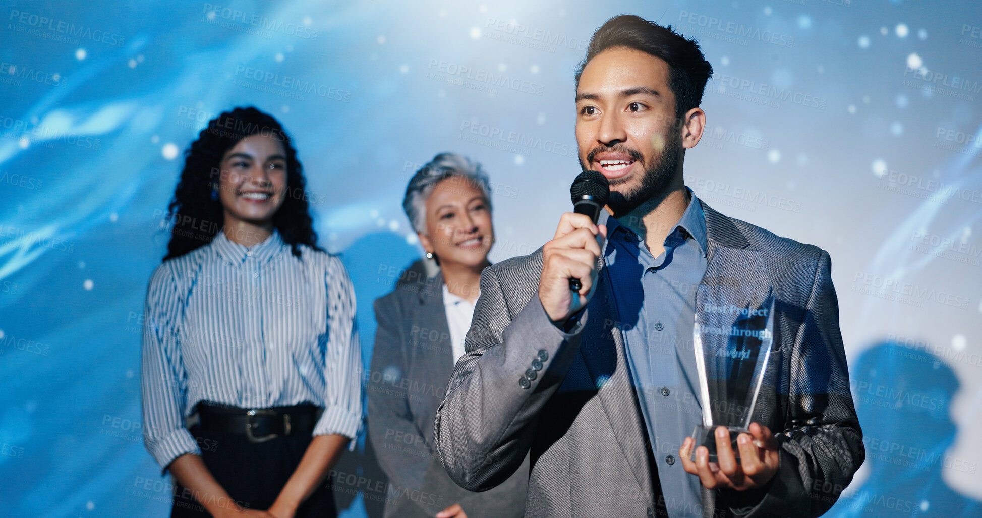 Buy stock photo Man, award and happy on conference stage, mic and acceptance speech for performance at company. Person, staff and trophy at event with thanks, goal and smile for reward with success in finance career