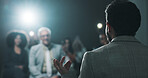 Man, back of speaker or presentation for press conference, development seminar or business event. Audience, speech and workshop for economy talk in auditorium with microphone, keynote and summit