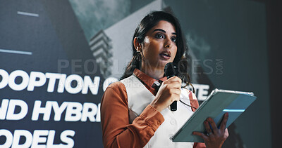 Buy stock photo Presentation, speech and tablet with Indian woman at symposium for hybrid business models. App, event and podium with corporate speaker in auditorium for introduction to remote work development