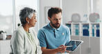 Tablet, advice and physiotherapy with old woman in office for consulting, healthcare and rehabilitation. Muscle recovery, medical and support with senior patient in clinic for physical therapy