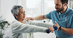 Mature woman, dumbbells and physiotherapist at clinic for rehabilitation, care or weight training. People, exercise and advice with equipment for recovery, muscle and healing for injury at hospital