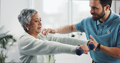Buy stock photo Mature woman, dumbbells and physiotherapist at clinic for rehabilitation, care or weight training. People, exercise and advice with equipment for recovery, muscle and healing for injury at hospital