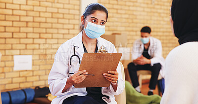 Buy stock photo Clipboard, face mask and non profit with doctor in community center for healthcare checkup. Consulting, documents and volunteer with medical professional at outreach event for charity or medicare