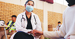Charity, support and nurse holding hands with patient for comfort, NGO campaign or counselling. Outreach event, face mask and person in community center with healthcare volunteer, advice and help