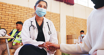 Buy stock photo Charity, support and nurse holding hands with patient for comfort, NGO campaign or counselling. Outreach event, face mask and person in community center with healthcare volunteer, advice and help