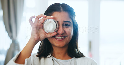 Buy stock photo Happy, woman and product for skincare in home, portrait or facial treatment for smooth skin or glow. House, smile and Indian person with cosmetics for beauty, moisturizer and dermatology for face