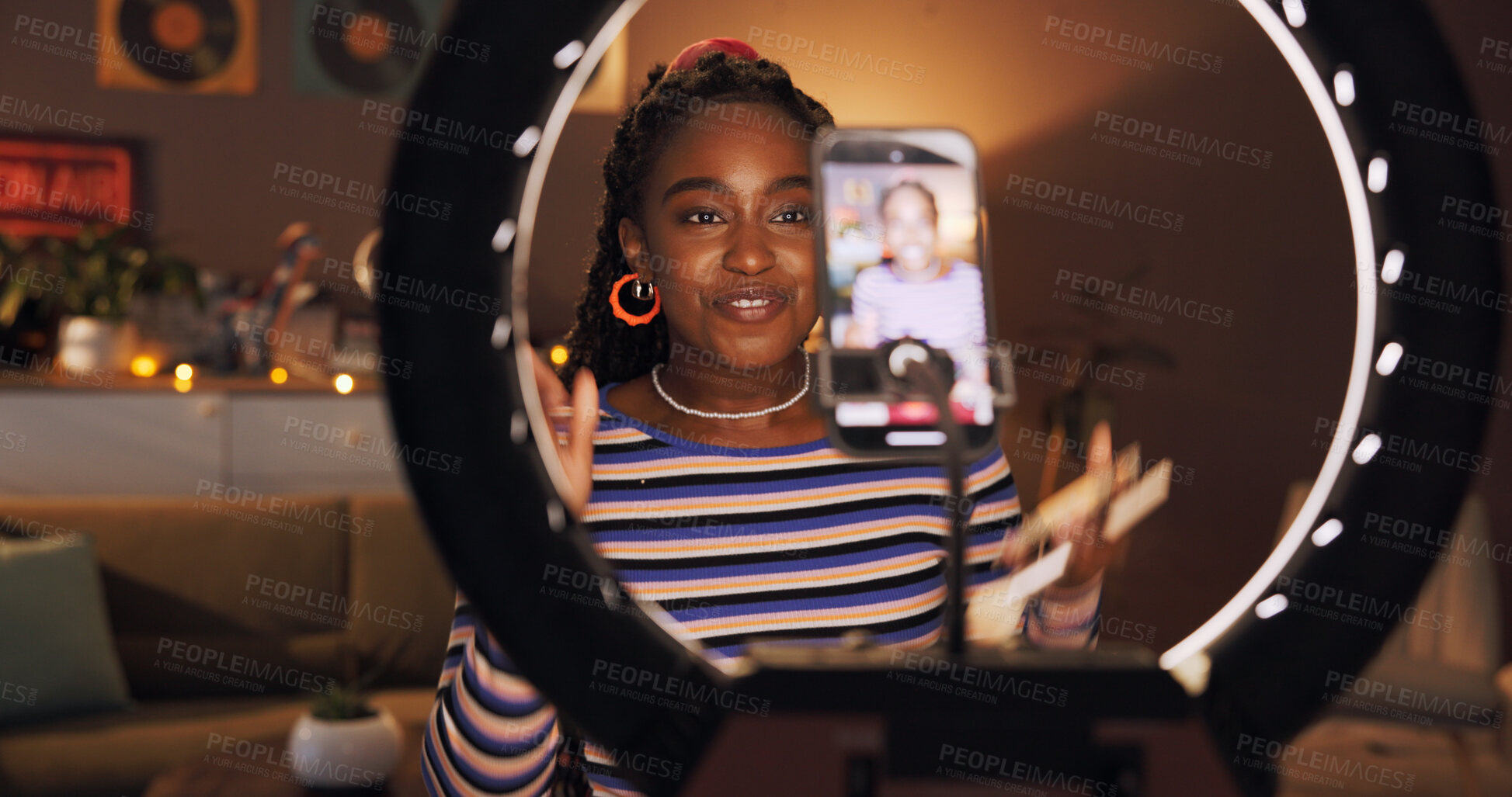 Buy stock photo Black woman, influencer and phone with ring light at house for introduction, late live streaming or social media. Night, content creator and wave to audience, filming video or vlog tutorial with tips