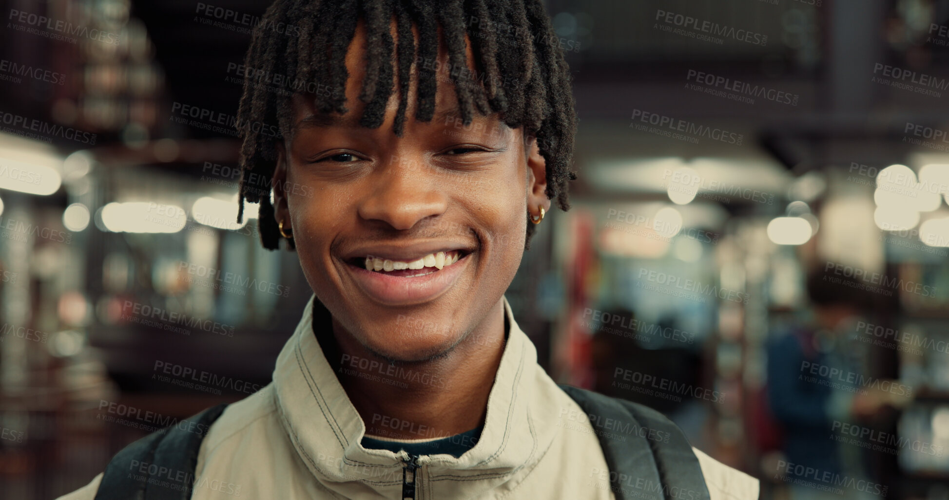 Buy stock photo College student, portrait and man with backpack in library for night study, research and learning. Bokeh, education and black person with smile on campus for essay deadline or assignment productivity