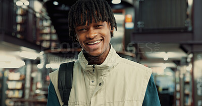 Buy stock photo College student, happy and man with backpack in library for night study, research and education. Portrait, learning and black person with smile on campus for essay deadline and assignment information